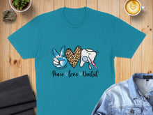 Load image into Gallery viewer, Teal t-shirt with "Peace love Dental" text and a peace sign, leopard print heart, and tooth.