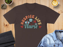 Load image into Gallery viewer, Brown t-shirt with "Hospice Nurse Life" text and medical icons.