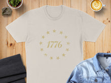 Load image into Gallery viewer, Tan t-shirt with "1776" and stars in a circular design.