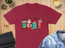 Load image into Gallery viewer, T-shirt featuring four coffee drinks decorated with medical symbols and the word "Nurse".