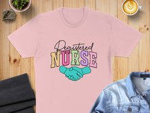 Load image into Gallery viewer, Pink t-shirt with "Registered Nurse" text and shaking hands graphic.