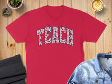 Load image into Gallery viewer, Red t-shirt with "TEACH" printed in floral and star pattern.