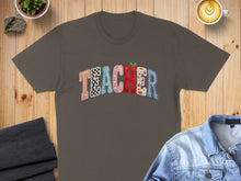 Load image into Gallery viewer, T-shirt with "TEACHER" in colorful, patterned block letters.
