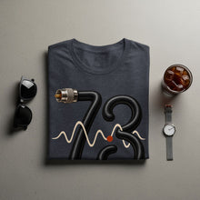 Load image into Gallery viewer, Dark t-shirt with graphic of cable forming "73" and a waveform.