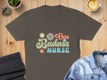 Load image into Gallery viewer, Retro floral text reads "One Badass Nurse" on a brown t-shirt.