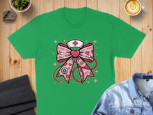 Load image into Gallery viewer, Green t-shirt featuring a pink nurse's bow with XOXO hearts and medical icons.