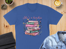 Load image into Gallery viewer, T-shirt with stacked books featuring inspirational words and floral design.