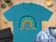 Load image into Gallery viewer, Teal t-shirt with colorful "Pediatric Nurse" text and rainbow graphic.
