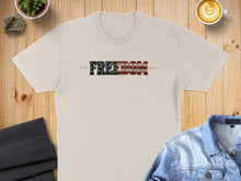 Load image into Gallery viewer, Light beige t-shirt with "FREEDOM" text in distressed American flag design.