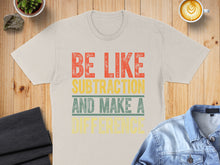 Load image into Gallery viewer, Cream t-shirt with "Be Like Subtraction and Make a Difference" text.