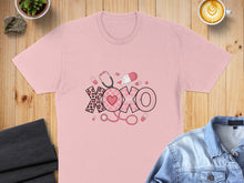Load image into Gallery viewer, Pink t-shirt with "XOXO" design featuring stethoscope, pills, and leopard print hearts.