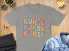 Load image into Gallery viewer, Gray t-shirt with "NURSE NURSE NURSE" in colorful retro lettering and floral accents.