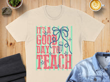 Load image into Gallery viewer, Light tan t-shirt with "It's a good day to teach" text and pencil graphic.