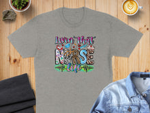 Load image into Gallery viewer, Grey t-shirt with "Lovin' that nurse life" text and medical icons.