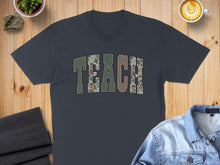 Load image into Gallery viewer, Dark grey t-shirt with "TEACH" in camouflage lettering.