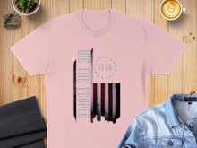Load image into Gallery viewer, Pink t-shirt with distressed American flag and "We The People" text.