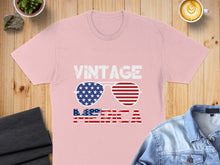 Load image into Gallery viewer, Pink t-shirt with sunglasses graphic featuring American flag design and "VINTAGE AMERICA" text.