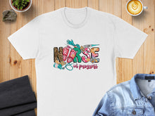 Load image into Gallery viewer, White t-shirt with "Nurse in progress" text and medical graphic.