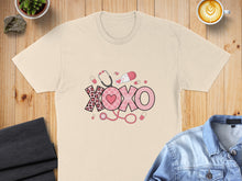 Load image into Gallery viewer, Cream t-shirt with pink "XOXO" graphic featuring medical icons.