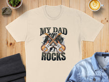 Load image into Gallery viewer, Cream t-shirt with "MY DAD ROCKS" and two crossed guitars.