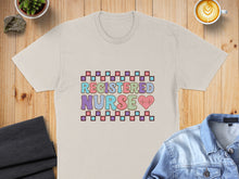 Load image into Gallery viewer, T-shirt with "REGISTERED NURSE" in colorful squares and heart graphic.