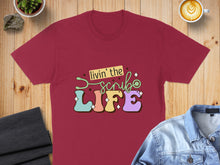 Load image into Gallery viewer, Burgundy t-shirt with "Livin' the Scrub Life" text and stethoscope graphic.