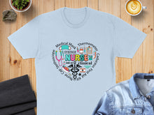 Load image into Gallery viewer, Light blue t-shirt with medical icons and "NURSE" text.