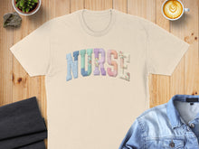 Load image into Gallery viewer, Cream t-shirt with "NURSE" spelled in colorful patchwork letters.