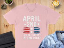 Load image into Gallery viewer, Pink t-shirt with "April 2nd Liberation Day in America!" text and flag stripes.