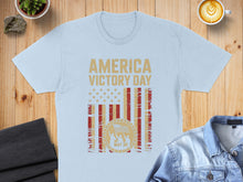 Load image into Gallery viewer, Light blue t-shirt with "America Victory Day May 08" and US flag graphic.