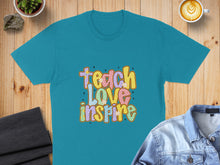 Load image into Gallery viewer, Teal t-shirt with "Teach Love Inspire" text in colorful retro font.