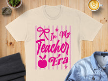 Load image into Gallery viewer, Cream t-shirt with "In My Teacher Era" text and pink stripes.