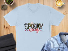 Load image into Gallery viewer, Light blue t-shirt with "Spooky Nurse" text and Halloween graphics.