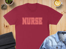 Load image into Gallery viewer, Maroon t-shirt with "NURSE" text, flat lay with jeans and coffee.