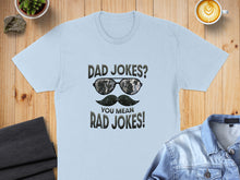 Load image into Gallery viewer, Light blue t-shirt with "Dad Jokes? You mean RAD JOKES!" text and sunglasses graphic.