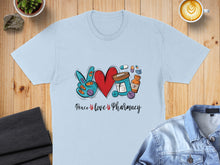 Load image into Gallery viewer, Light blue t-shirt with "Peace, Love, Pharmacy" text and graphic of pills and heart.