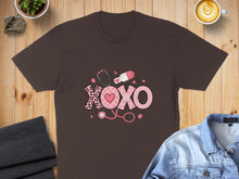 Load image into Gallery viewer, Brown t-shirt with "XOXO" design featuring stethoscope, heart, and pill.