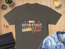 Load image into Gallery viewer, Brown t-shirt with "Nursing is in My DNA" text and a syringe graphic.