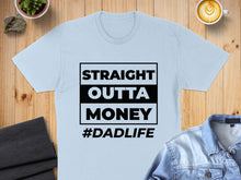 Load image into Gallery viewer, Light blue t-shirt with "STRAIGHT OUTTA MONEY #DADLIFE" text.