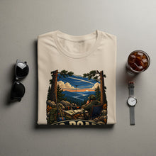 Load image into Gallery viewer, T-shirt with graphic of man using ham radio in scenic mountain landscape.