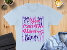 Load image into Gallery viewer, Light blue t-shirt with "You Can Do Hard Things" text and ribbons.