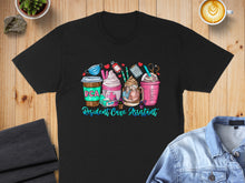 Load image into Gallery viewer, Black t-shirt with colorful cartoon "Resident Care Assistant" drinks and medical icons.