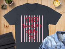 Load image into Gallery viewer, Dark gray t-shirt with "Tired Teacher's Club" text on pink stripes.