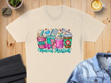 Load image into Gallery viewer, Cream t-shirt with colorful Medical Assistant themed drinks and medical icons.