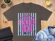 Load image into Gallery viewer, Brown t-shirt with "Teacher Mode" text, ribbons, and a pencil icon.