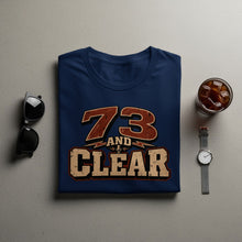 Load image into Gallery viewer, Navy t-shirt with "73 AND CLEAR" text and microphone graphic.