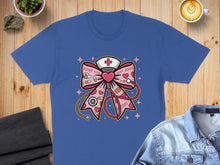 Load image into Gallery viewer, Blue t-shirt with pink medical-themed bow design featuring hearts and XOXO.