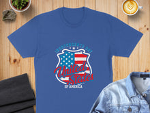 Load image into Gallery viewer, Blue t-shirt with "Independence Day United States of America" shield graphic.