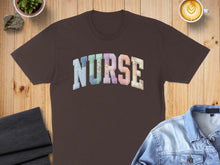 Load image into Gallery viewer, Brown t-shirt with "NURSE" text in colorful patchwork letters.