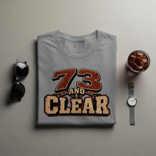 Load image into Gallery viewer, Grey t-shirt with "73 and Clear" text and microphone graphic.